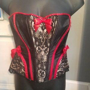 Black and tan lace corset with red bows and trim